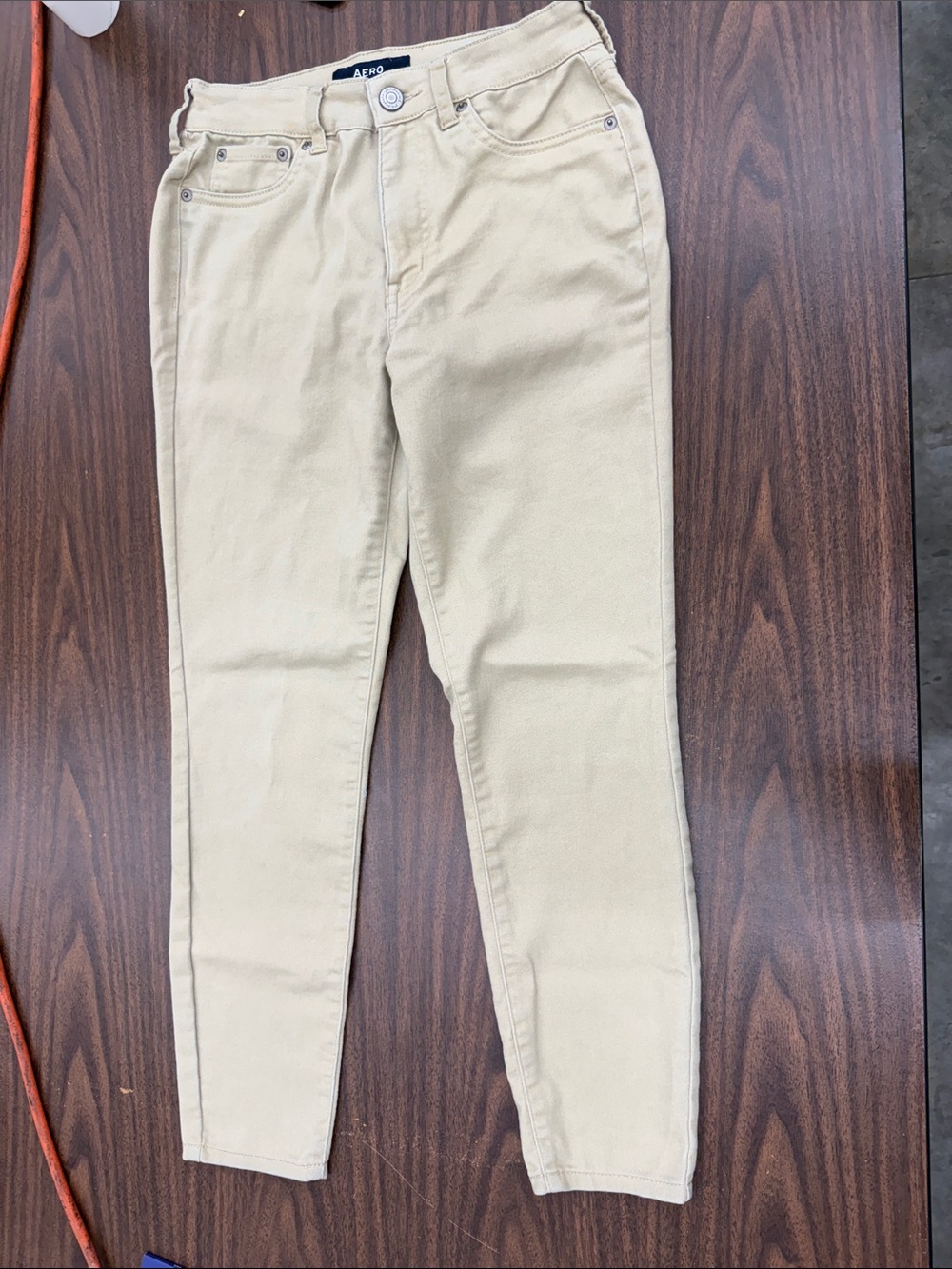 High-Rise Slim Chino Pants in Cream by AERO